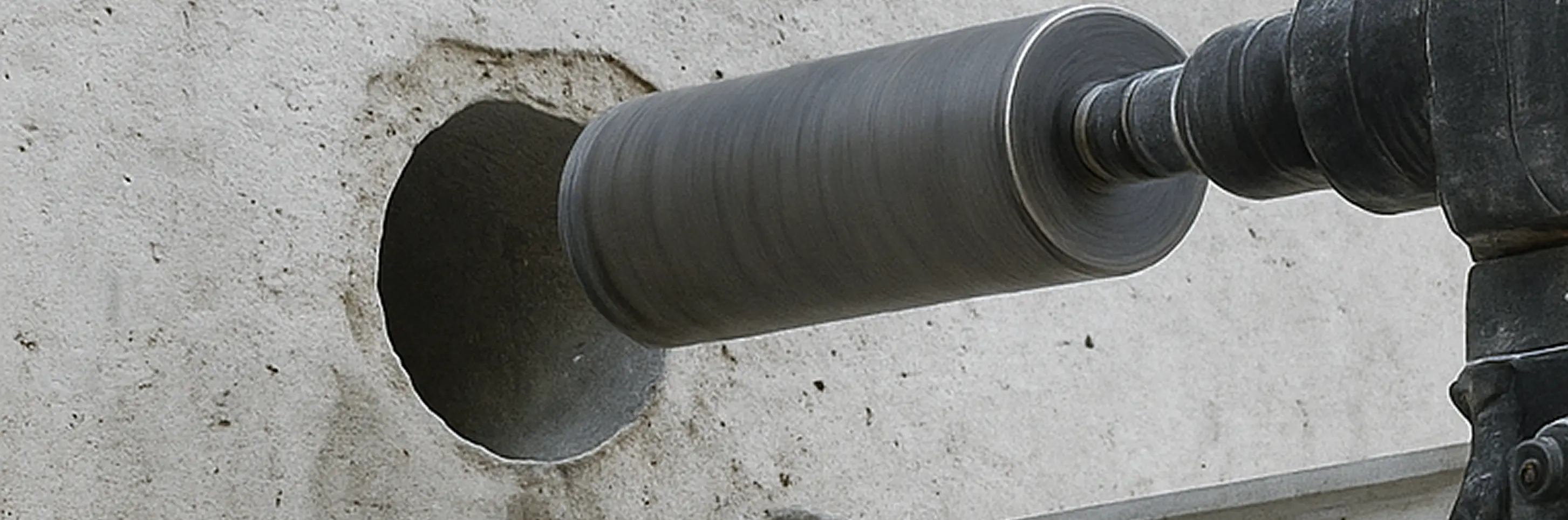 Image of a tool drilling into concrete wall.